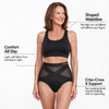 Woman wearing the black Anuvio criss-cross high-waist shaping brief, with callouts for the shaped waistline, all-day comfort and criss-cross X support